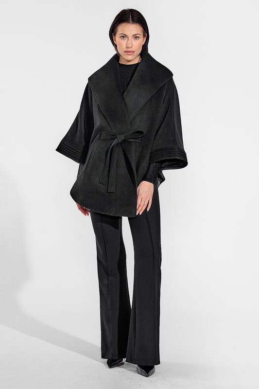 Sentaler Cape with Shawl Collar and Belt featured in Baby Alpaca and available in Black. Seen from front on female model who is wearing the coat belted.