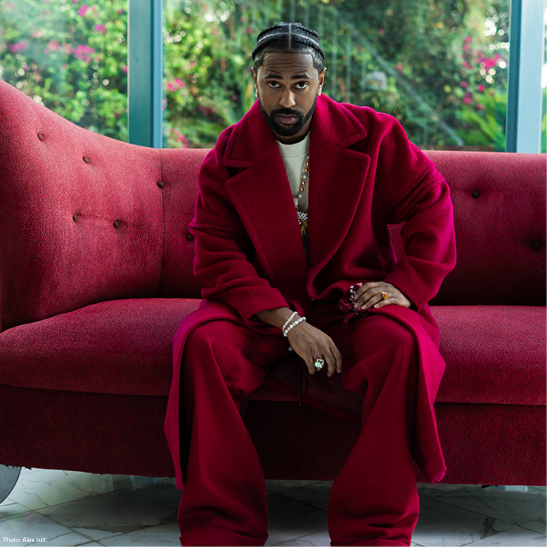 American rapper Big Sean is wearing the SENTALER Men Technical Bouclé Alpaca Robe Coat in Fuchsia and seen from the waist up.