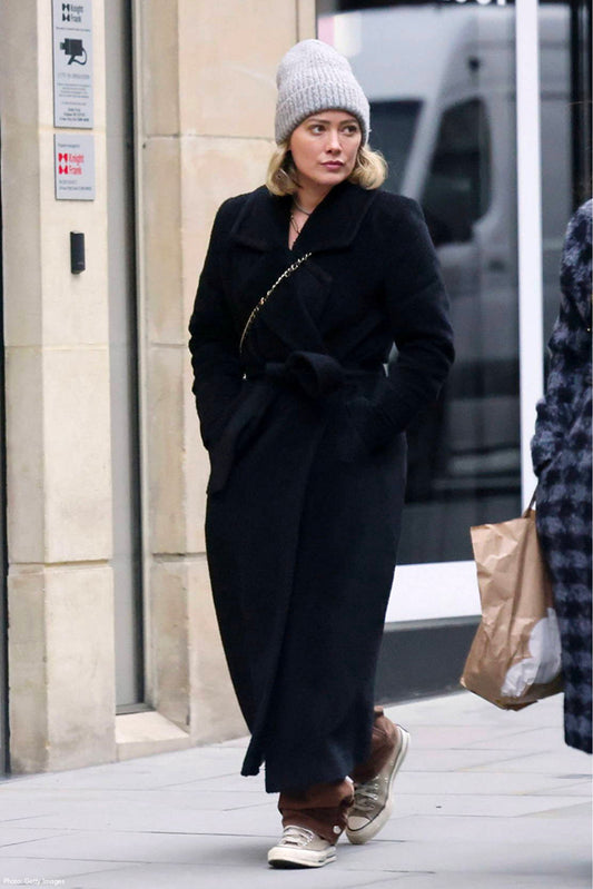 American actress Hillary Duff is wearing the SENTALER Bouclé Alpaca Long Notched Collar Wrap Coat in Black walking in the streets of London.