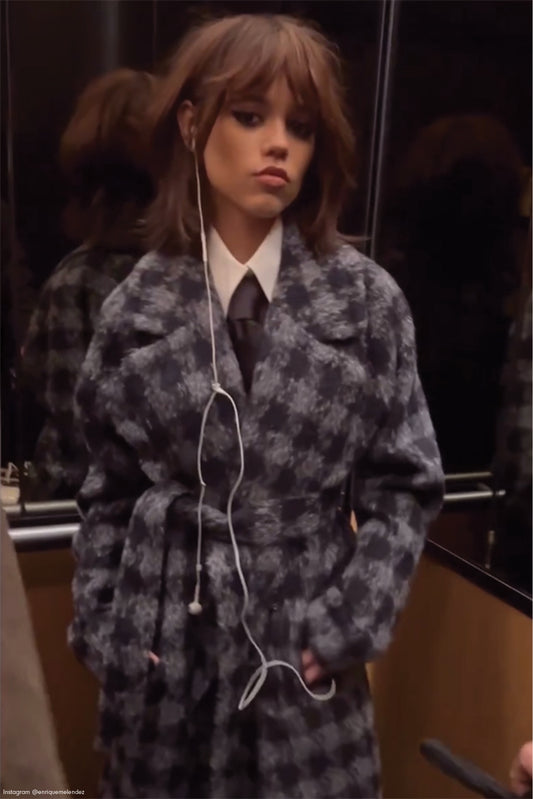 American actress Jenna Ortega is wearing the SENTALER Houndstooth Alpaca Long Raglan Sleeve Notched Collar Coat in Navy Houndstooth in an elevator in New York.