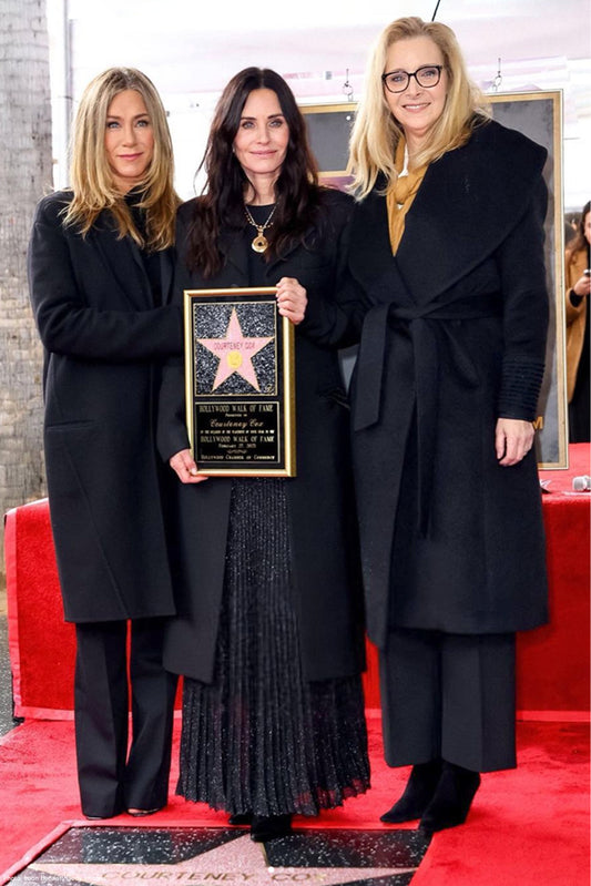 American actress Lisa Kudrow is wearing the SENTALER Suri Alpaca Long Shawl Collar Wrap Coat in Black while posing with Jennifer Aniston and Courtney Cox at Cox's Hollywood Walk of Fame ceremony.