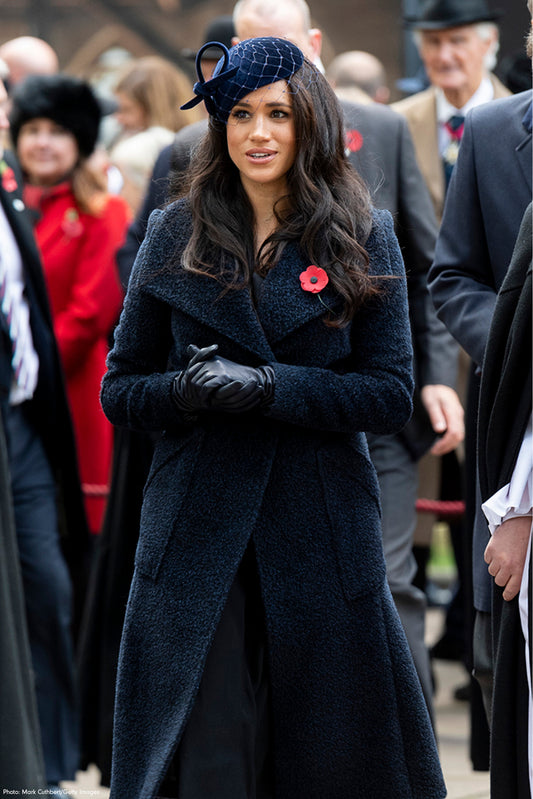 The Duchess of Sussex Meghan Markle is wearing the SENTALER Bouclé Alpaca Long Wide Collar Wrap Coat in Navy walking to Westminster Abbey's Field.