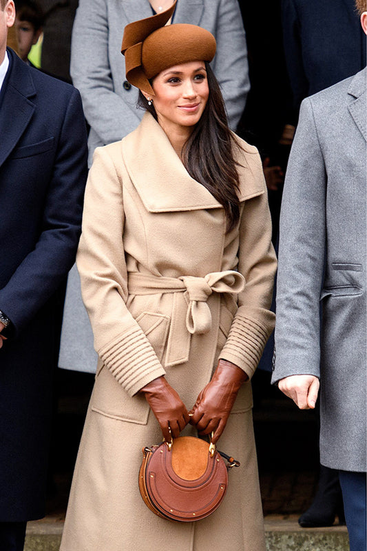 The Duchess of Sussex Meghan Markle is wearing the SENTALER Long Wide Collar Wrap Coat in Camel on Christmas Day with the royal family.