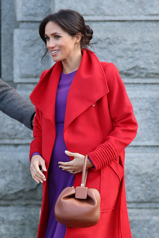 The Duchess of Sussex Meghan Markle is wearing the SENTALER Long Wide Collar Wrap Coat in Scarlet Red visiting Birkenhead.