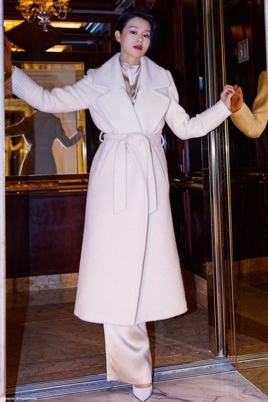 Hong Kong actress and singer Myolie Wu is wearing the SENTALER Bouclé Alpaca Long Notched Collar Wrap Coat in Ivory White while posing in an elevator.