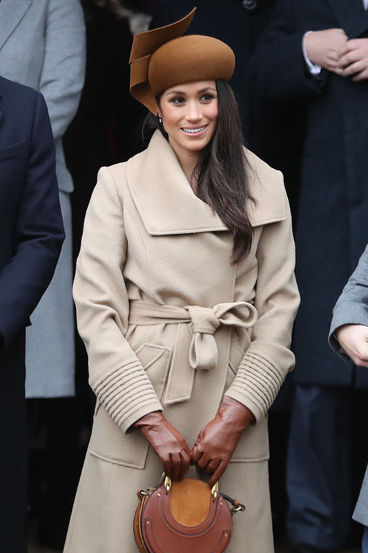 Image features the Best Health logo and an image of the Duchess of Cambridge, Meghan Markle wearing the Sentaler Long Wide Collar Wrap Coat featured in Baby Alpaca and available in Camel.