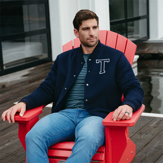 Image features the Fashion logo and an image of Toronto Maple Leafs Captain, John Tavares wearing the SENTALER x John Tavares Varsity Jacket in Technical Baby Alpaca in Deep Navy. 