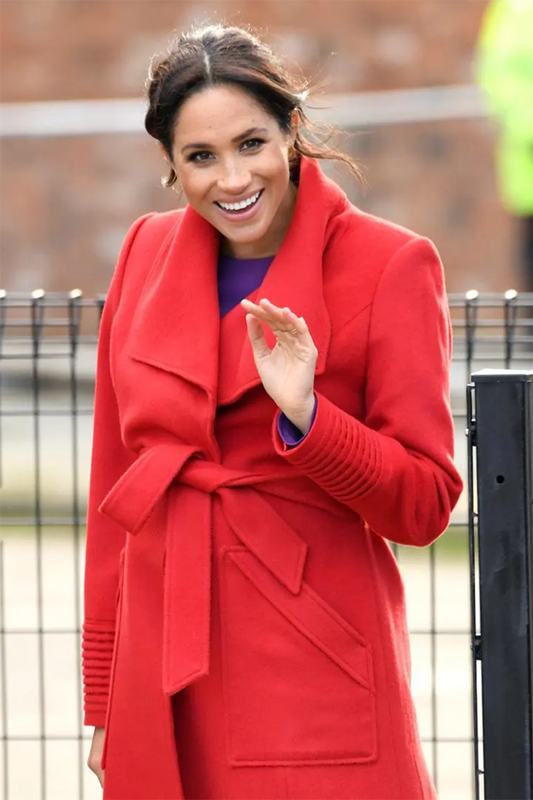 Image features the Forbes logo and an image of the Duchess of Cambridge, Meghan Markle wearing the Sentaler Long Wide Collar Wrap Coat featured in Baby Alpaca and available in Scarlet Red.