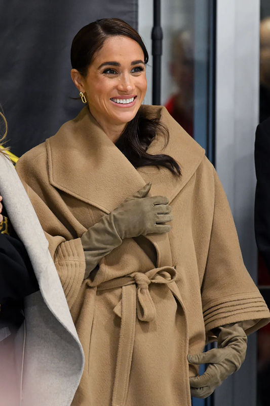 Image features the Marie Claire logo and an image of the Duchess of Sussex, Meghan Markle wearing the Baby Alpaca Cape with Shawl Collar and Belt featured in Baby Alpaca and available in Dark Camel.