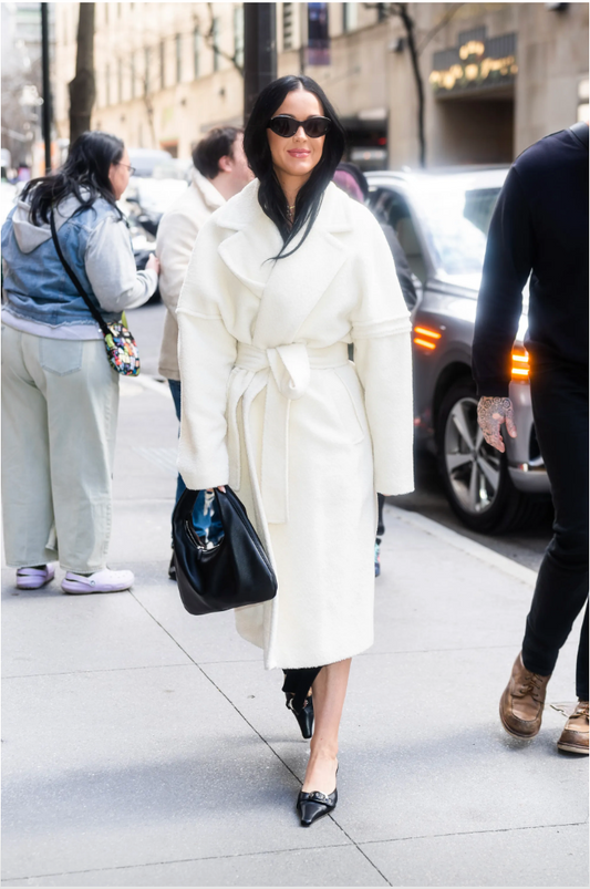 Image features the Vogue logo and an image of Katy Perry wearing the Sentaler Technical Bouclé Alpaca Robe Coat featured in Technical Bouclé Alpaca and available in Ivory White. 