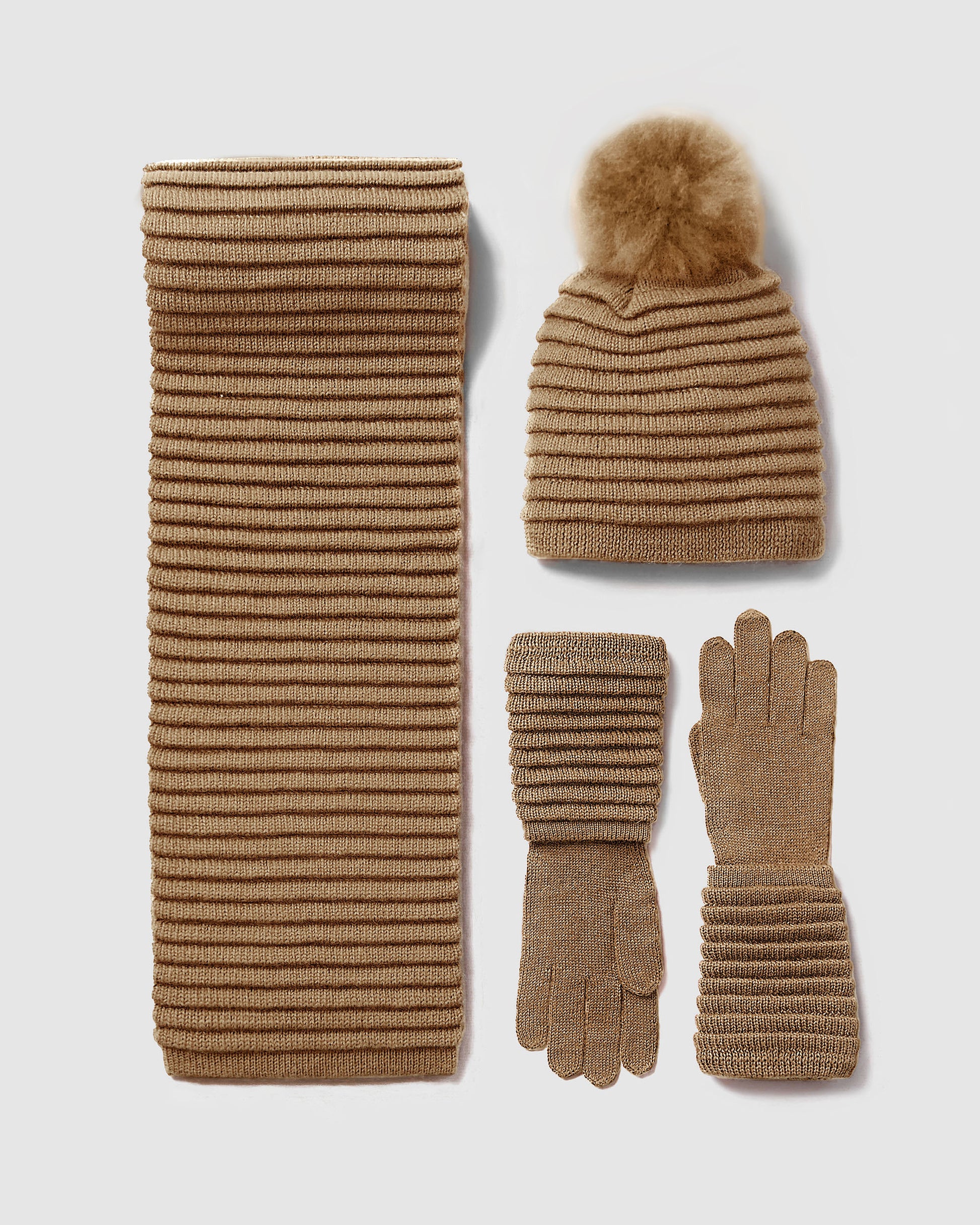 Sentaler women’s dark camel ribbed winter accessories set including hat, scarf, and gloves made of Baby Alpaca fabric displayed on a on white background.