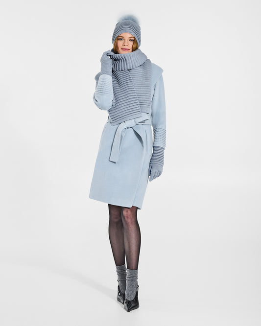 Front view of model wearing Sentaler's signature glacial blue ribbed hat, scarf, and gloves, paired with a matching glacial blue coat.