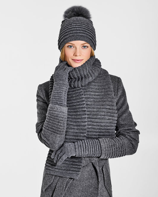 Front view of model wearing Sentaler's signature grey mélange ribbed hat, scarf, and gloves, paired with a matching grey mélange coat.
