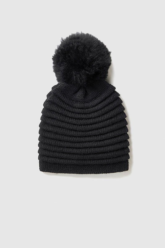 Sentaler Adult Ribbed Hat With Oversized Fur Pompon featured in Baby Alpaca and available in Black. Seen as off figure.