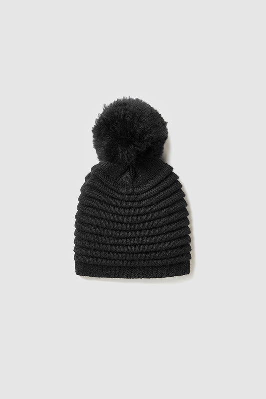 Sentaler Kids (6-14 Years) Ribbed Hat with Oversized Fur Pompon featured in Baby Alpaca and available in Black. Seen as off figure.