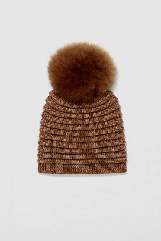 Sentaler Adult Ribbed Hat With Oversized Fur Pompon featured in Baby Alpaca and available in Caramel. Seen as off figure.