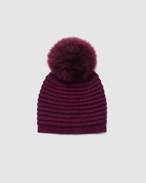 Sentaler women’s cherry lacquer ribbed winter hat made of Baby Alpaca fabric with oversized fur pompom, displayed on a white background.