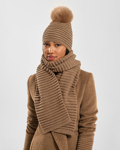 Sentaler Adult Ribbed Dark Camel Hat With Fur Pompon and Adult Ribbed Dark Camel Scarf in Baby Alpaca yarn. Seen from front close up on female model.