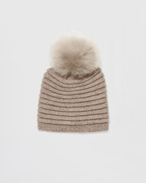 Sentaler women’s light taupe ribbed winter hat made of Baby Alpaca fabric with oversized fur pompom, displayed on a white background.