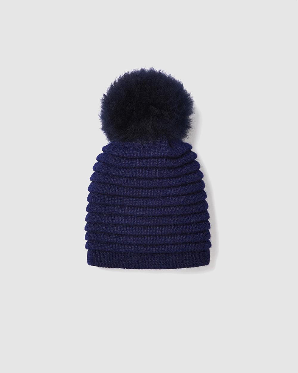 Sentaler women’s navy ribbed winter hat made of Baby Alpaca fabric with oversized fur pompom, displayed on a white background.