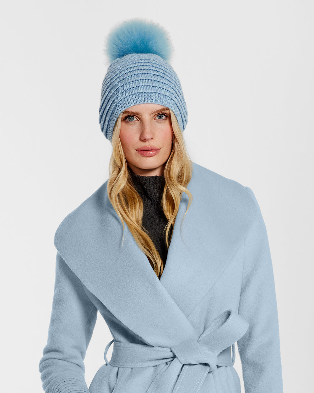 Sentaler Adult Ribbed Powder Blue Hat with Oversized Fur Pompon in Baby Alpaca wool. Seen from front close up on female model.