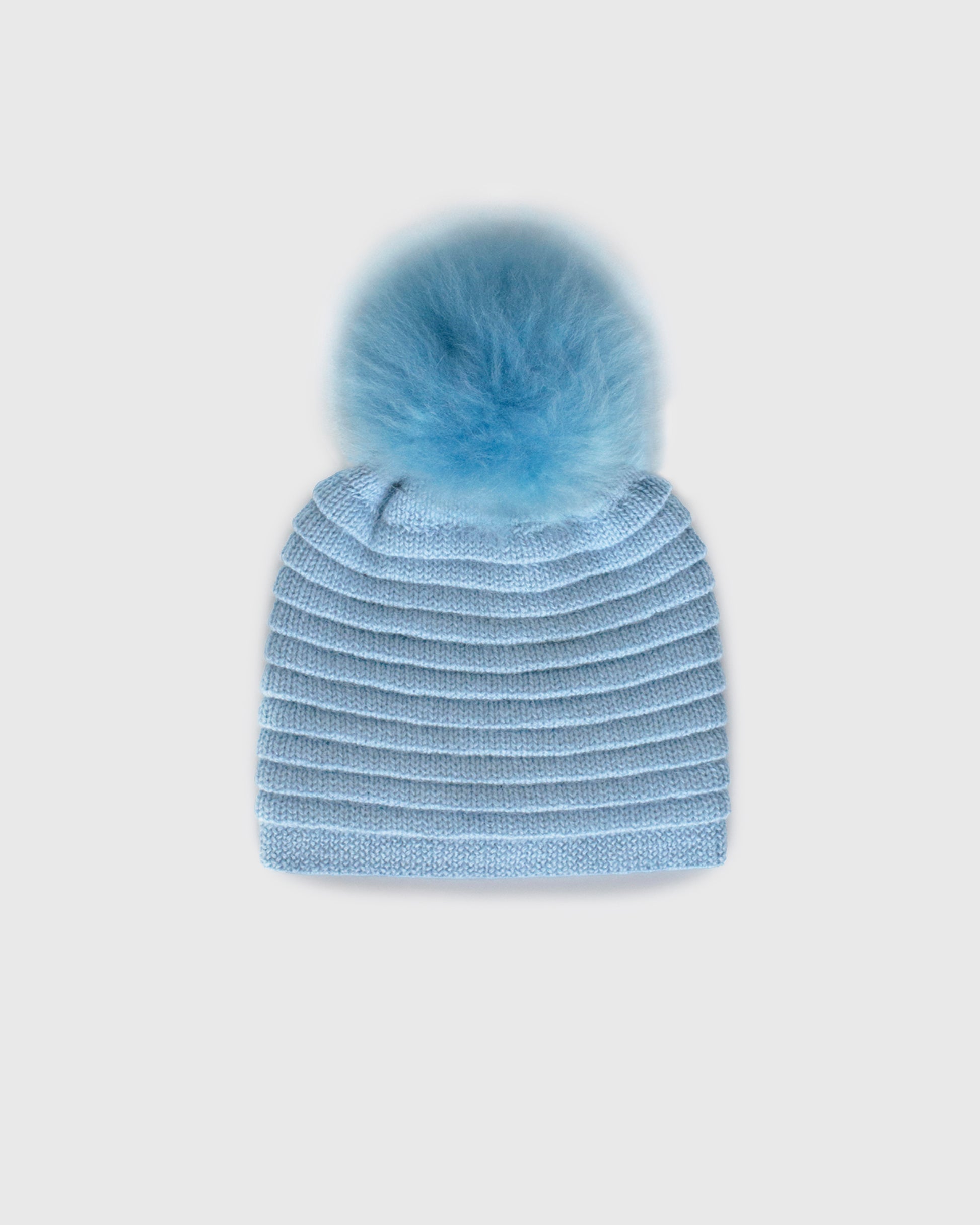 Sentaler women’s powder blue ribbed winter hat made of Baby Alpaca fabric with oversized fur pompom, displayed on a white background.