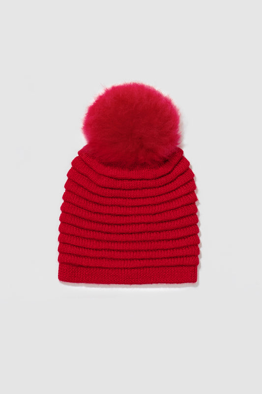 Sentaler Adult Ribbed Hat With Oversized Fur Pompon featured in Baby Alpaca and available in Red. Seen as off figure.