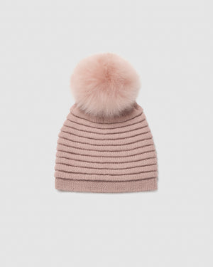 Sentaler women’s blush pink ribbed winter hat made of Baby Alpaca fabric with oversized fur pompom, displayed on a white background.