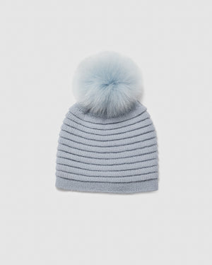 Sentaler women’s glacial blue ribbed winter hat made of Baby Alpaca fabric with oversized fur pompom, displayed on a white background.