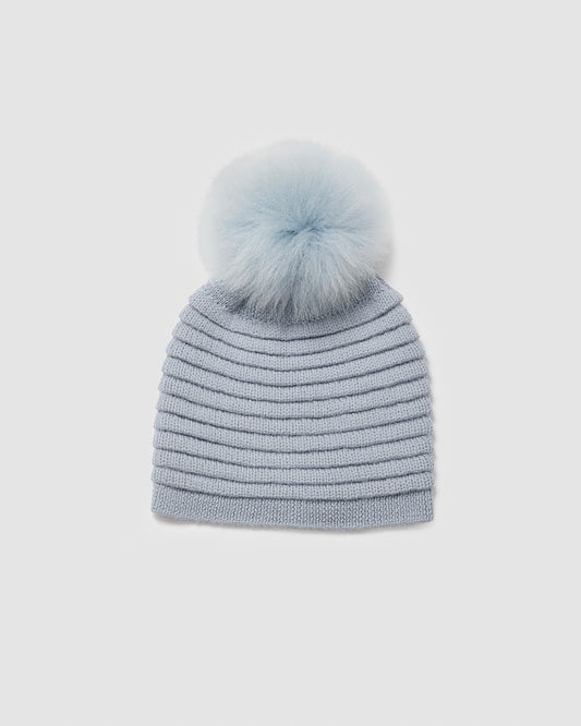 Sentaler women’s glacial blue ribbed winter hat made of Baby Alpaca fabric with oversized fur pompom, displayed on a white background.