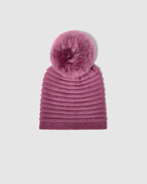Sentaler women’s mauve pink ribbed winter hat made of Baby Alpaca fabric with oversized fur pompom, displayed on a white background.