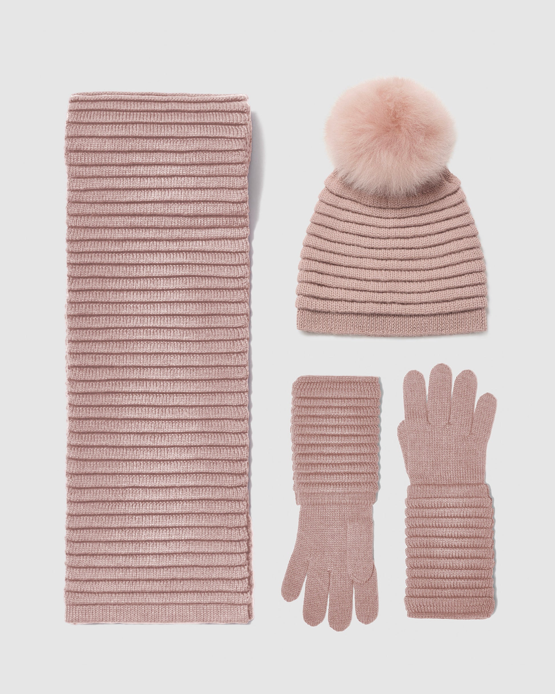 Sentaler women’s blush pink ribbed winter accessories set including hat, scarf, and gloves made of Baby Alpaca fabric displayed on a white background.