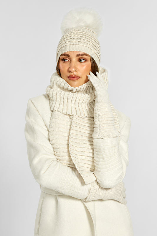 Sentaler Adult Ribbed Gloves, Ribbed Hat with Oversized Fur Pompon and Ribbed Gloves crafted in Baby Alpaca and in Ivory. Seen from front on model.