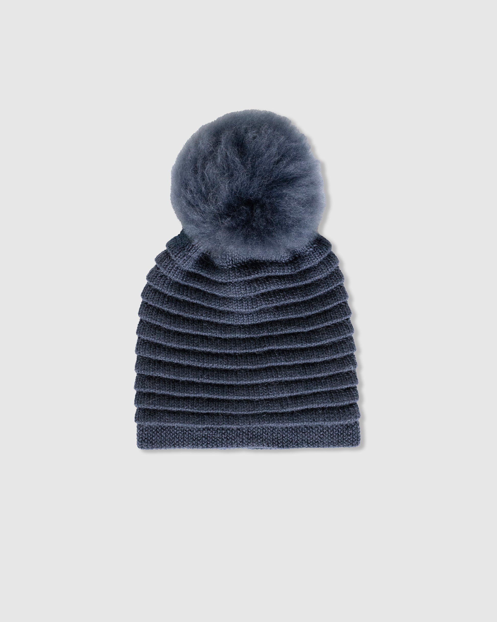 Sentaler women’s graphite ribbed winter hat made of Baby Alpaca fabric with oversized fur pompom, displayed on a white background.