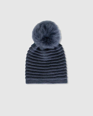Sentaler women’s graphite ribbed winter hat made of Baby Alpaca fabric with oversized fur pompom, displayed on a white background.