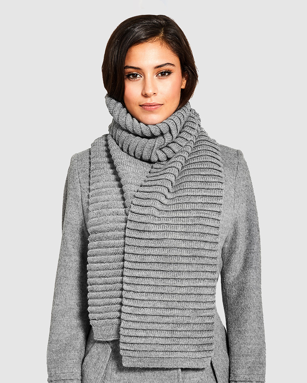 Sentaler Adult Ribbed Grey Scarf in Baby Alpaca yarn. Seen from front close up on female model.