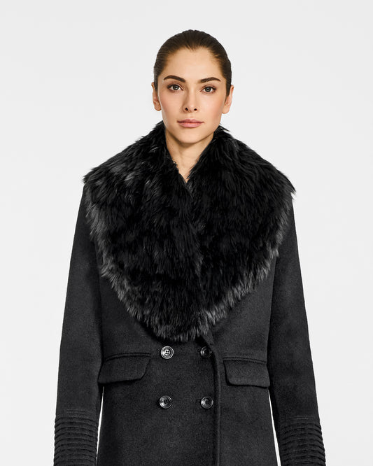 Front view of model wearing Sentaler's black alpaca shearling shawl collar, paired with a black coat.