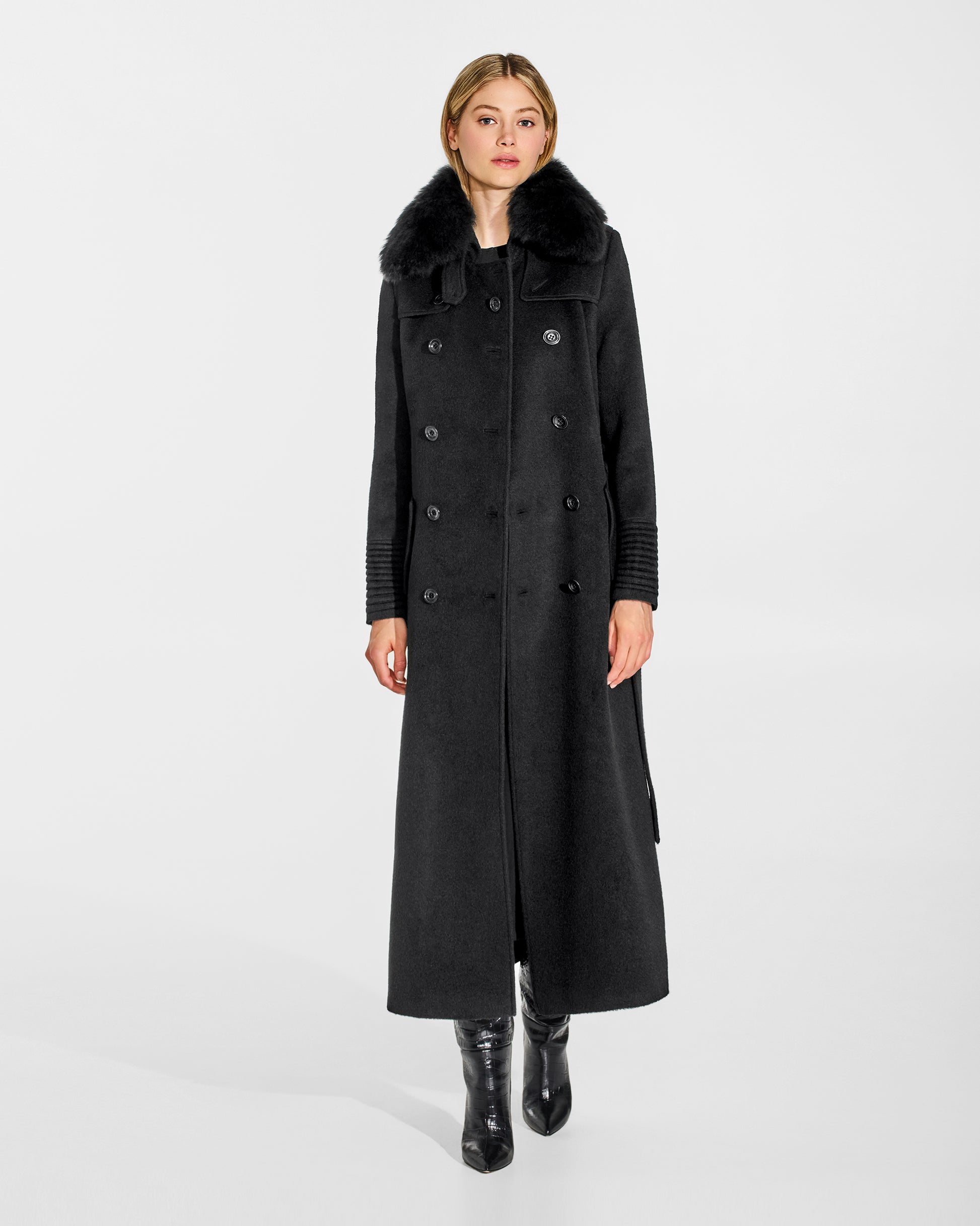 Front view of model wearing Sentaler's black alpaca shearling spread collar, paired with a black coat.