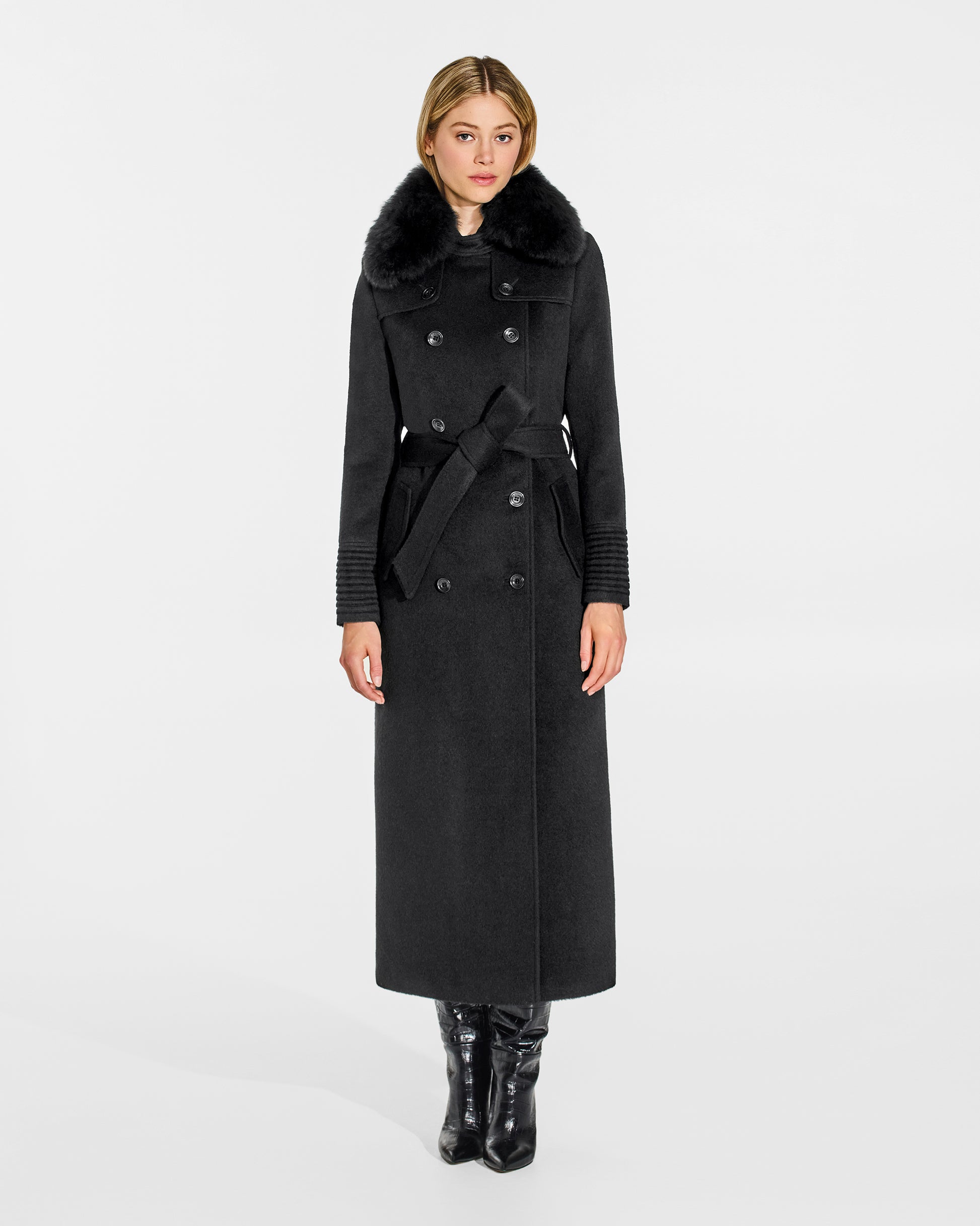 Front view of model wearing Sentaler's black alpaca shearling spread collar, paired with a black coat.