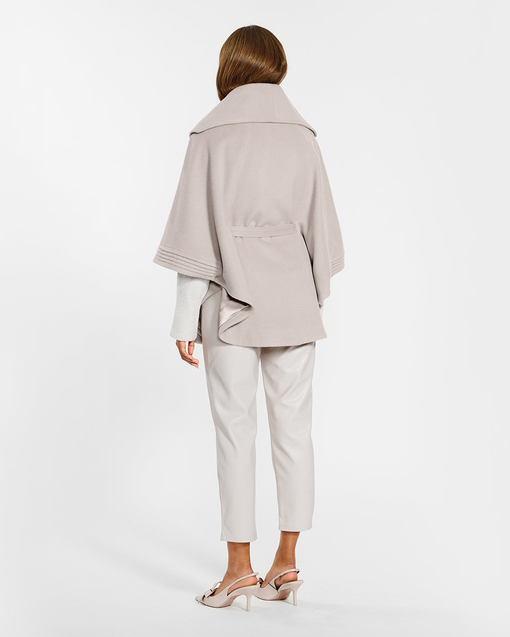 Sentaler Bleeker Beige Cape with Shawl Collar and Belt in Baby Alpaca wool. Seen from back belted on female model.