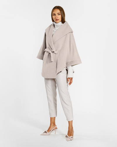 Sentaler Bleeker Beige Cape with Shawl Collar and Belt in Baby Alpaca wool. Seen from side belted on female model.