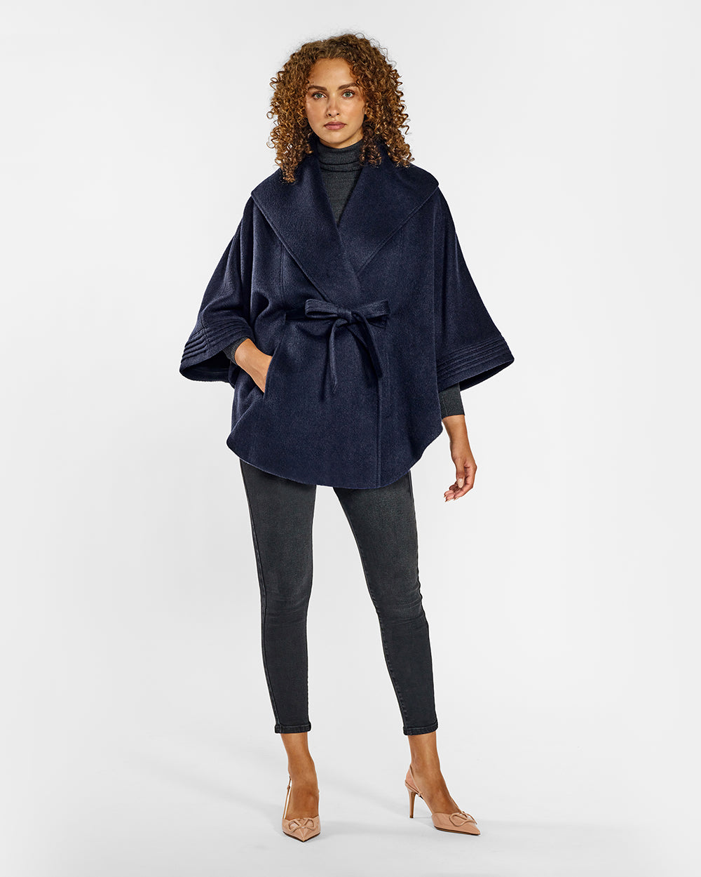 Sentaler Deep Navy Cape with Shawl Collar and Belt in Baby Alpaca wool. Seen from front belted on female model.