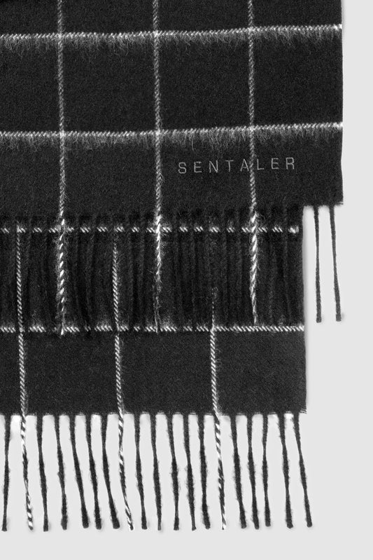 Sentaler Baby Alpaca Check Classic Scarf featured in Baby Alpaca and available in Black Check Black. Seen as off figure close up.
