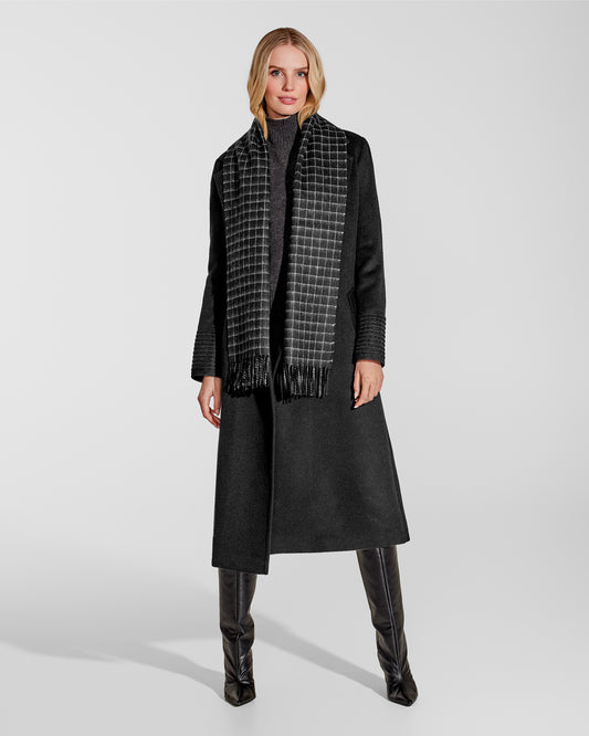 Front view of model wearing Sentaler's adult Black Check classic scarf, made of baby alpaca yarn. 