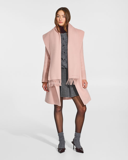 Front view of model wearing Sentaler's adult Blush Pink classic scarf, made of baby alpaca yarn. 