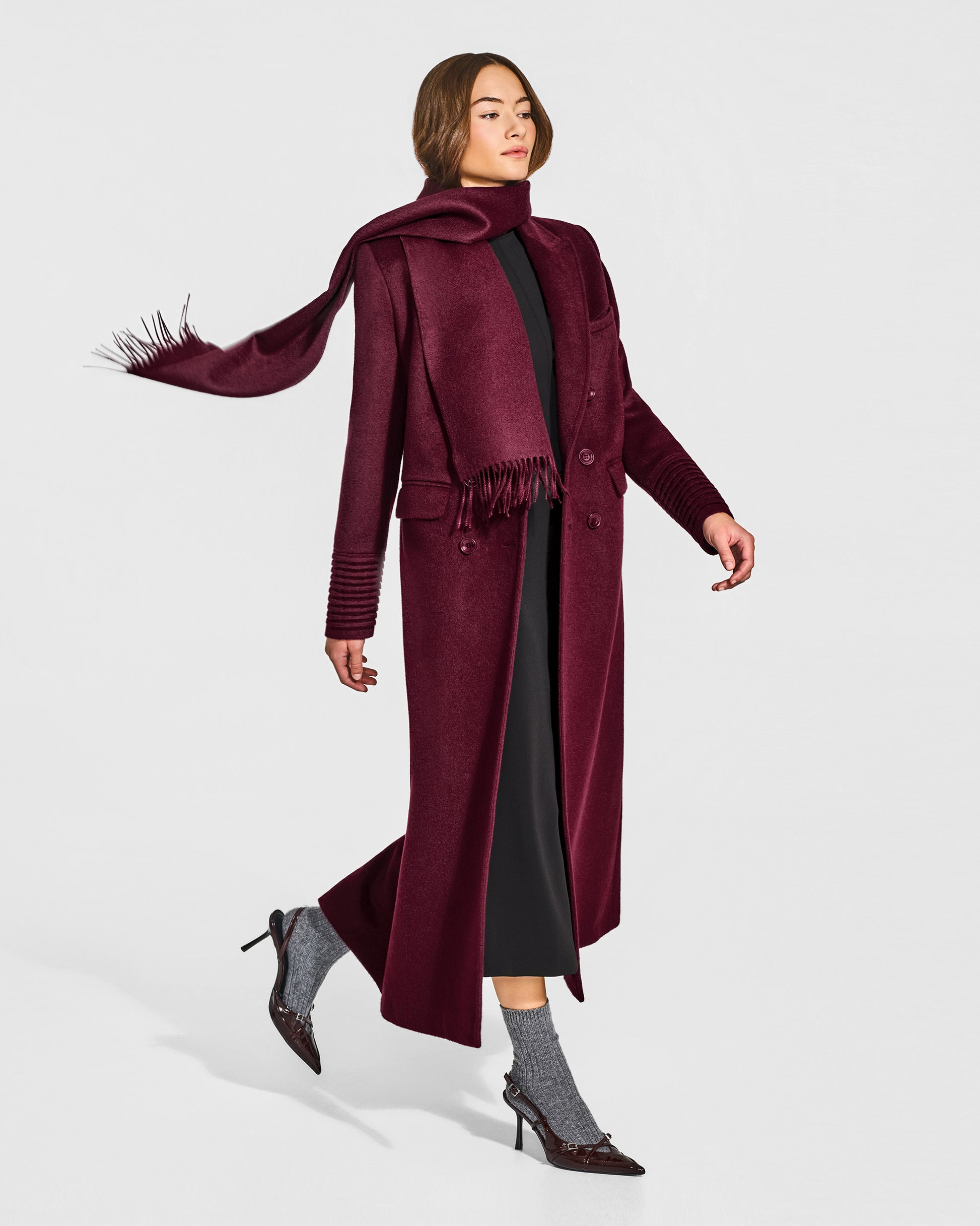 Side view of model wearing Sentaler's adult Cherry Lacquer classic scarf, made of baby alpaca yarn. 