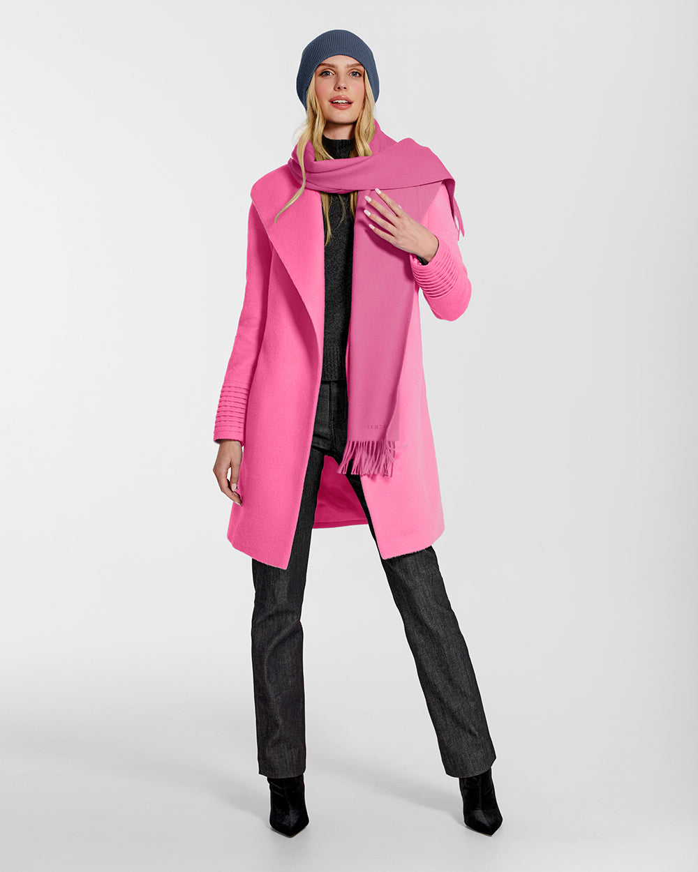 Front view of model wearing Sentaler's adult Cosmetic Pink classic scarf, made of baby alpaca yarn. 