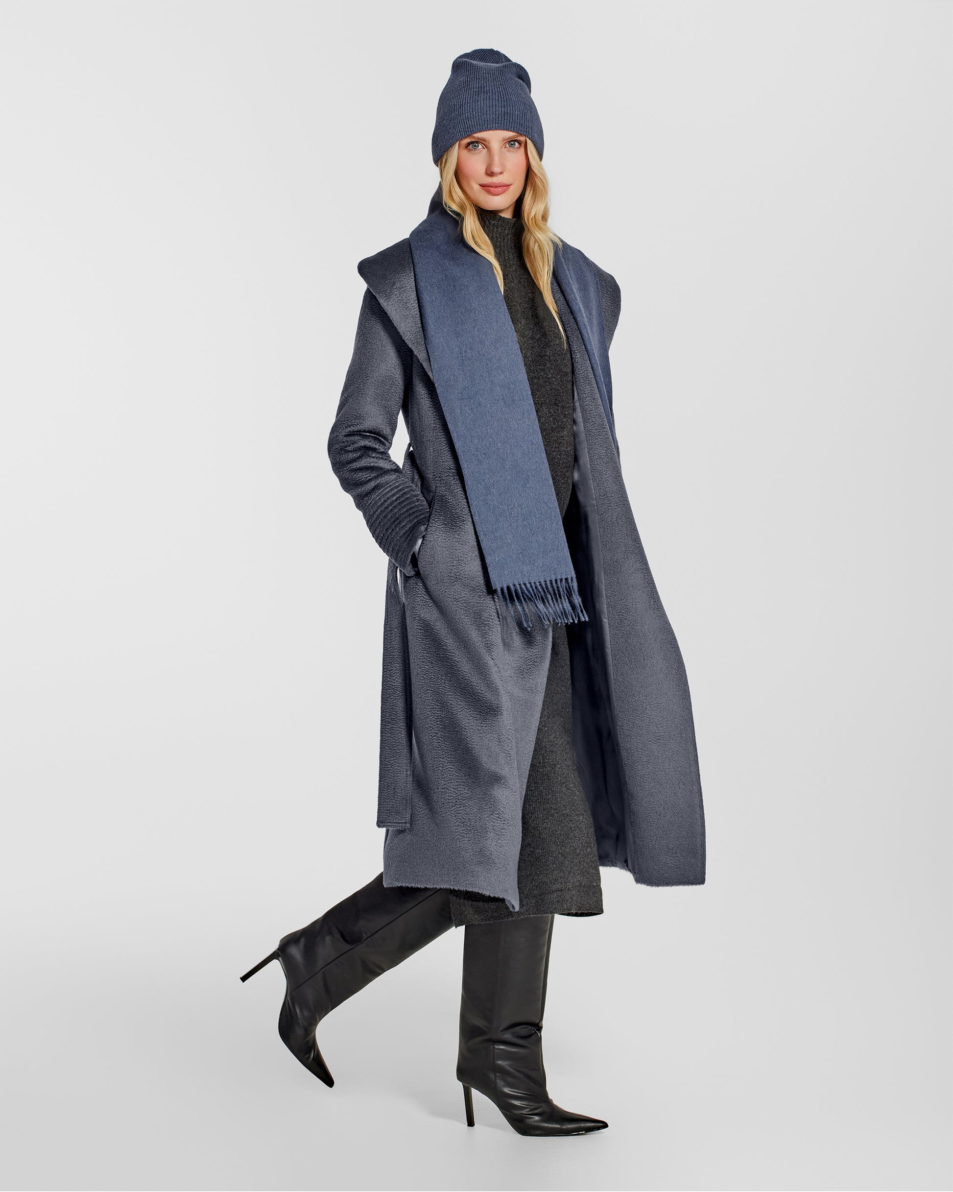 Side view of model wearing Sentaler's adult Graphite grey classic scarf, made of baby alpaca yarn. 