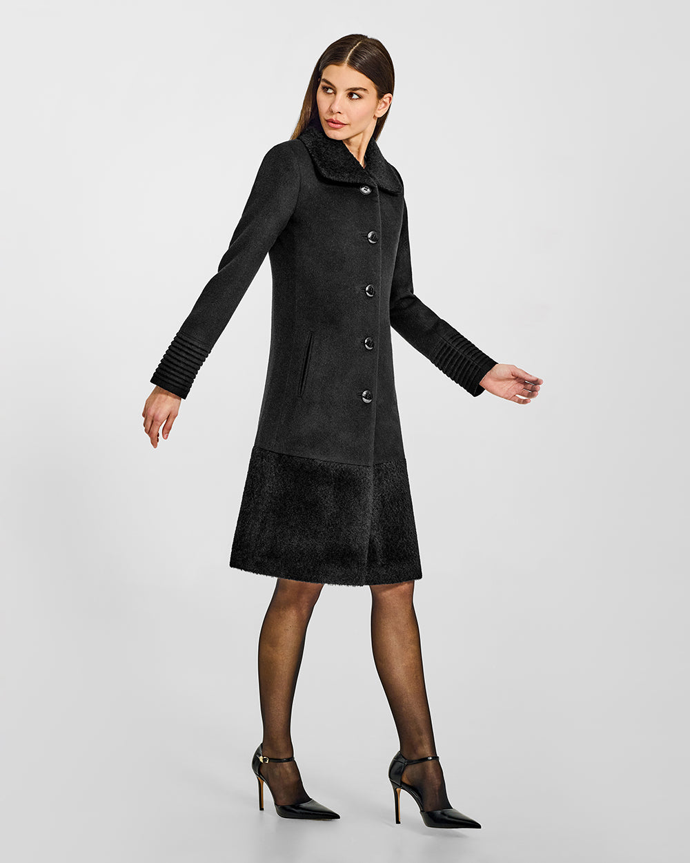 Sentaler A-line Black Coat with Bouclé Alpaca Collar and Trim in Baby Alpaca wool. Seen from side on female model.