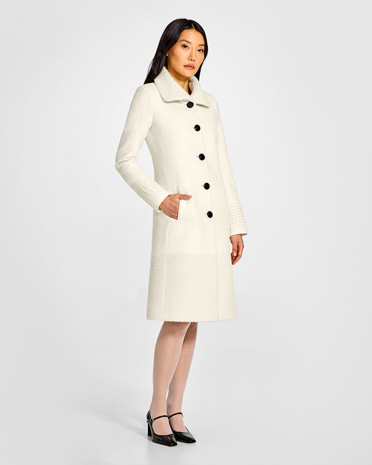 Sentaler A-line Ivory Coat with Bouclé Alpaca Collar and Trim in Baby Alpaca wool. Seen from side on female model.